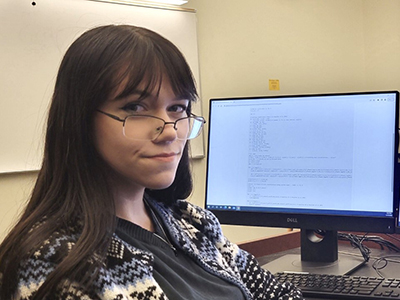 Ula Jones in front of a computer screen